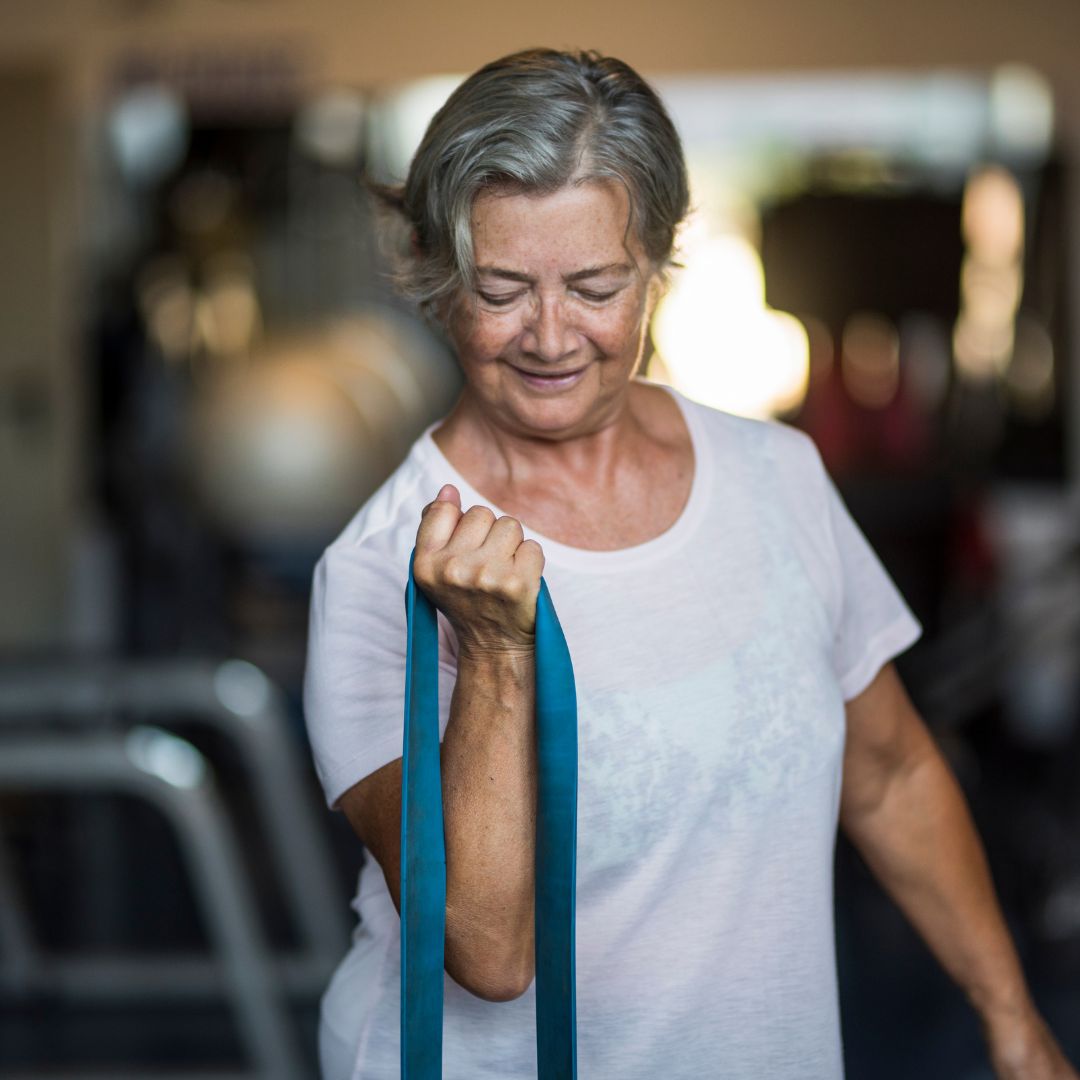 Senior lady exercising with resistance band